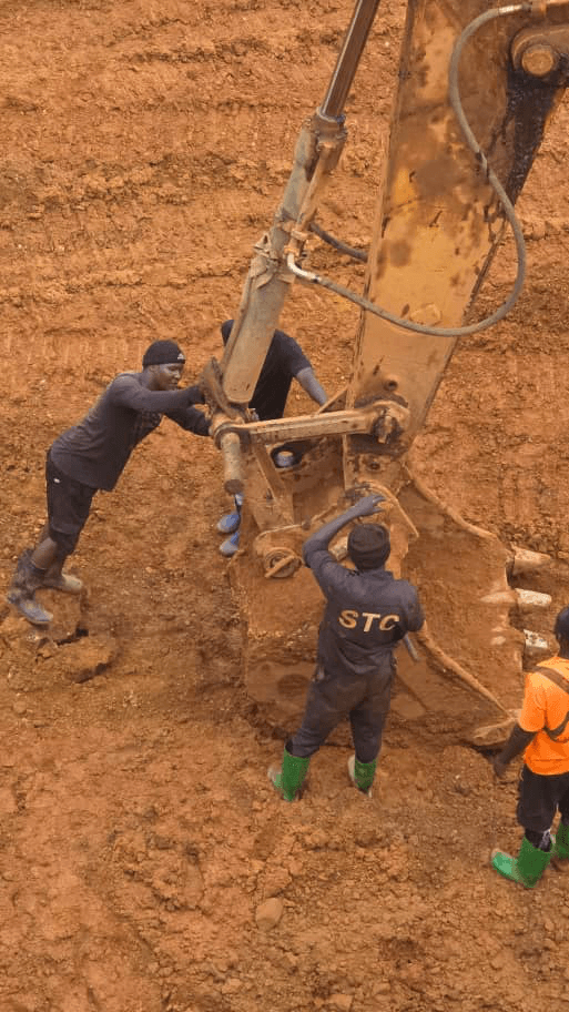 BYM technical team performing excavator maintenance at active site, eastern DRC